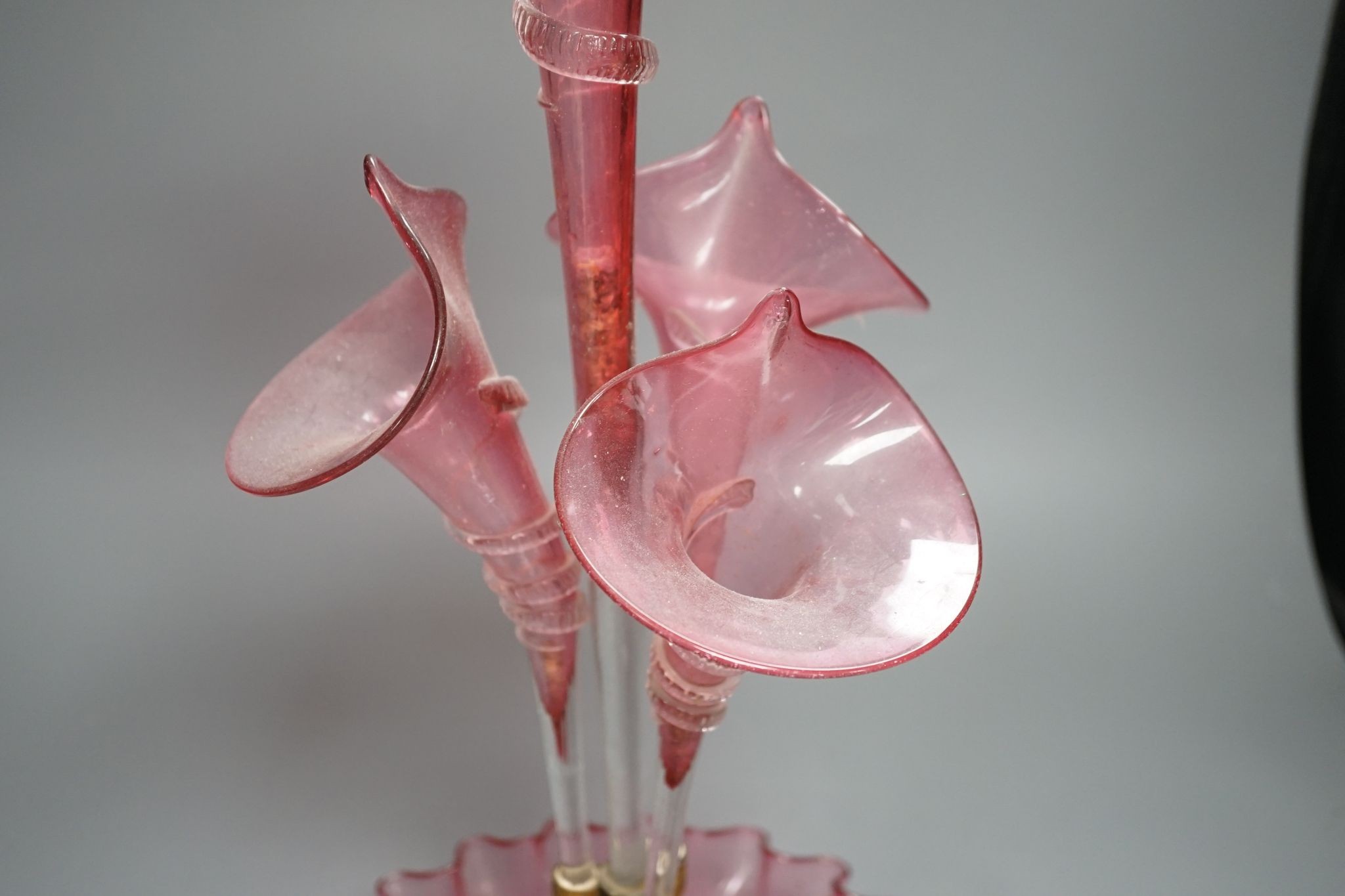 A Victorian cranberry glass four vase table centrepiece, 52 cms high.